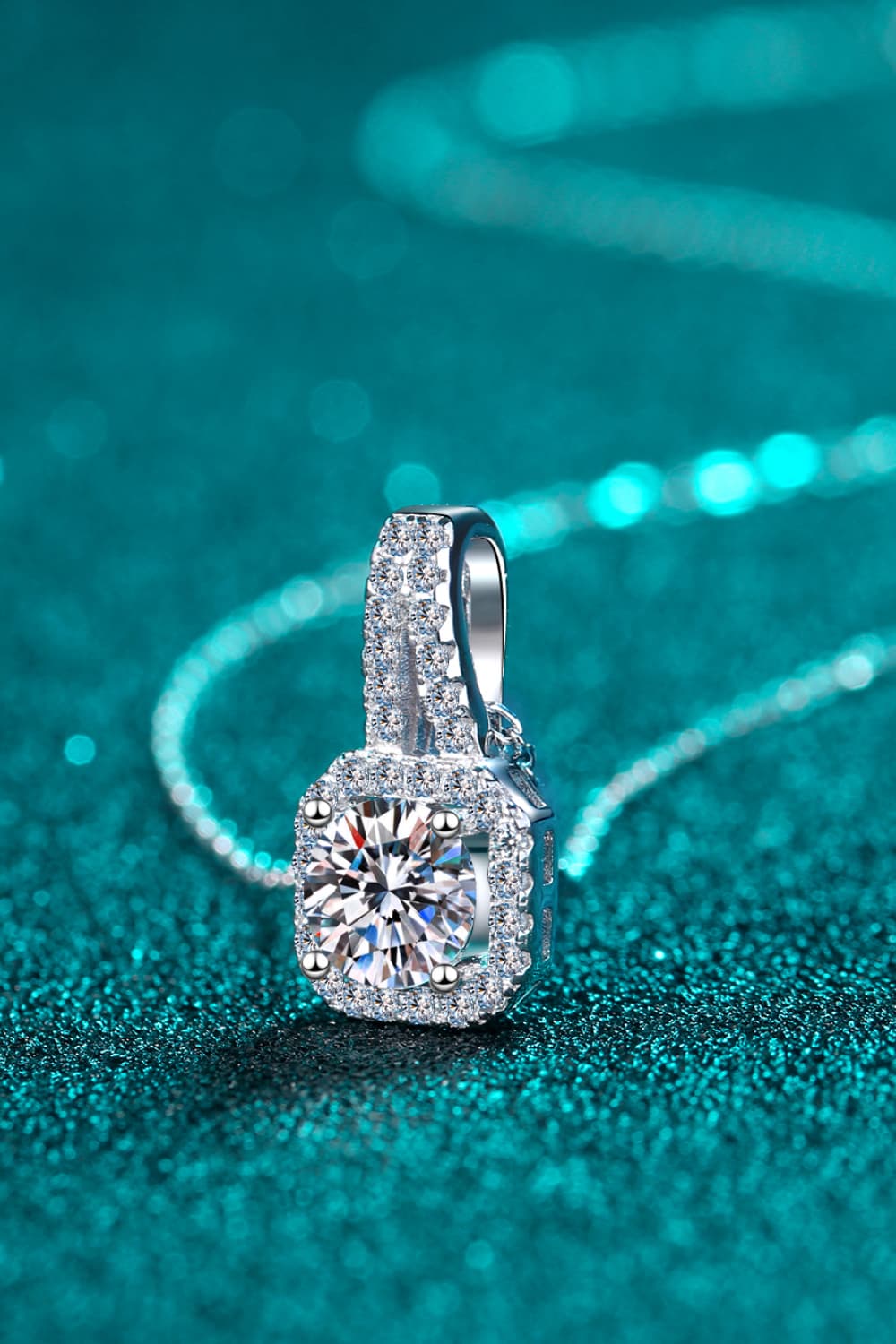 Silver cushion halo moissanite pendant necklace with a delicate chain.