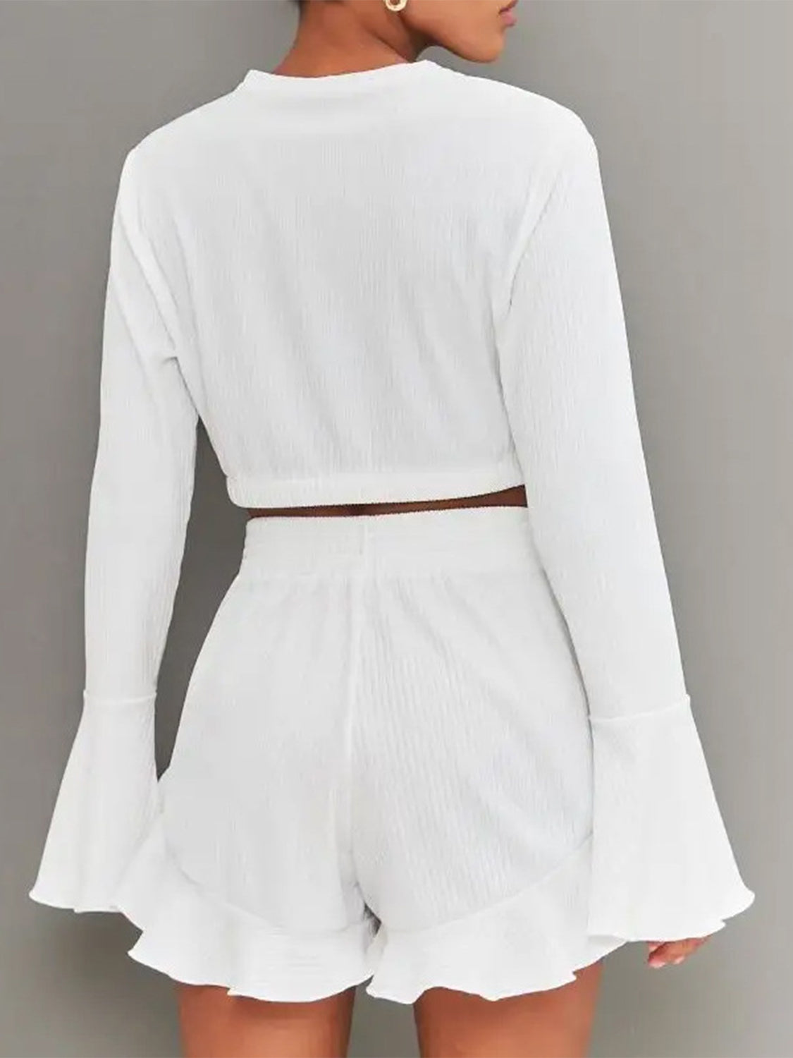 White ribbed crop set with flared sleeves and ruffled shorts