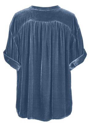 Dusty blue velvet button-down blouse with mandarin collar and cuffed short sleeves.