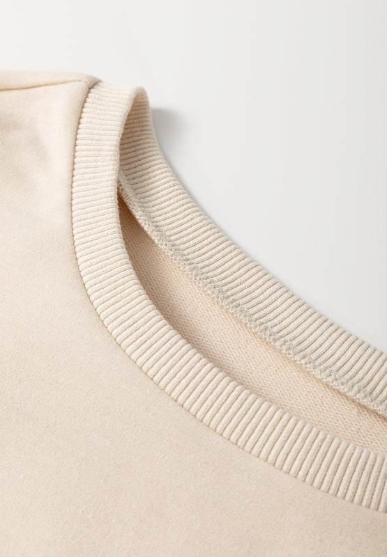Beige knit tunic top with ribbed neckline detail
