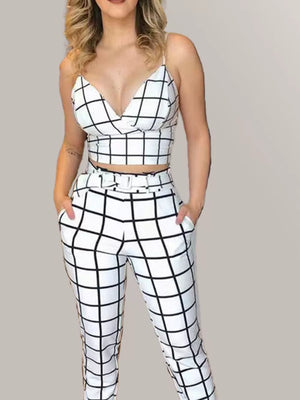 Chic white and black grid print two-piece set with crop top and belted pants.