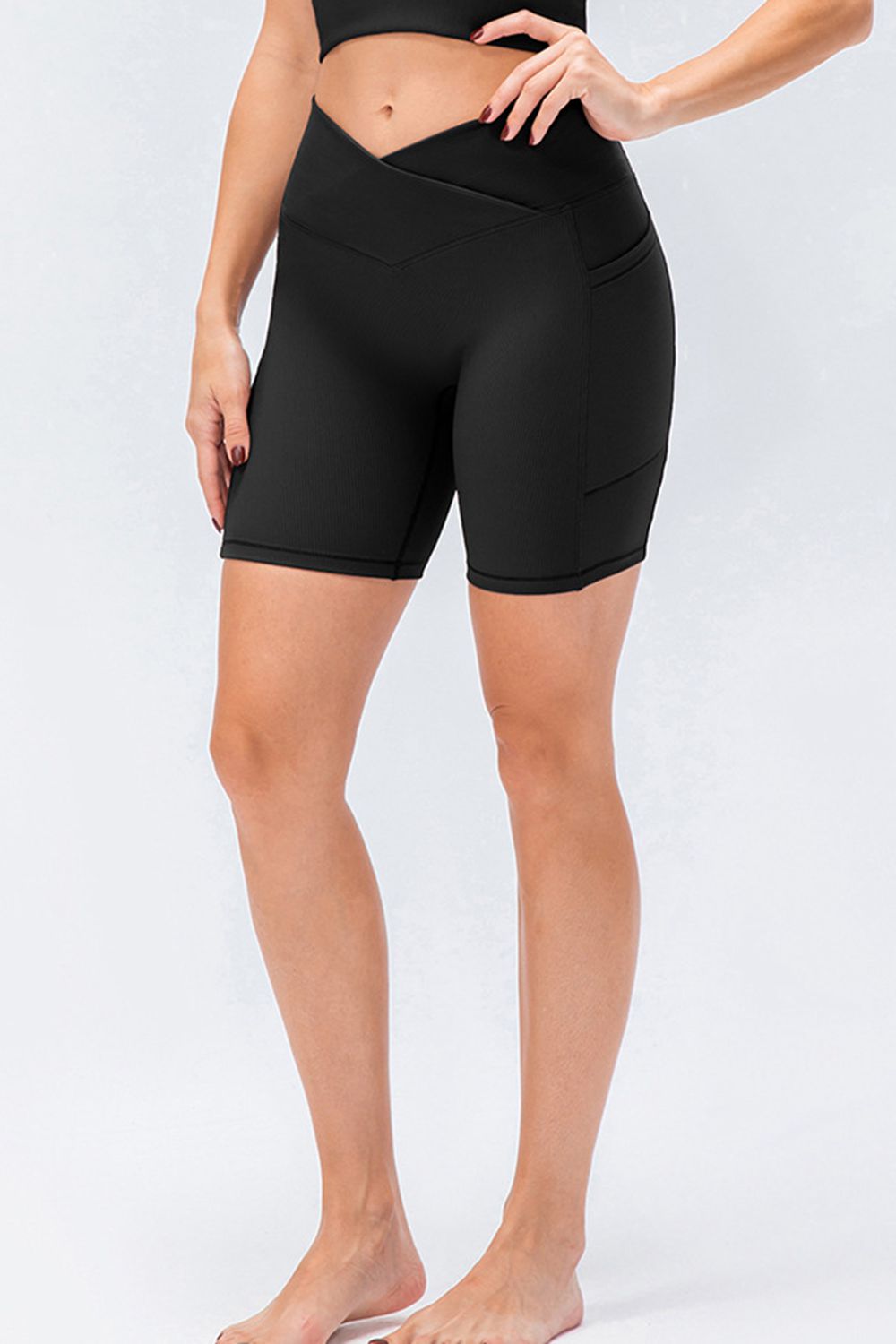 Black ribbed cross-waist bike shorts with side pockets
