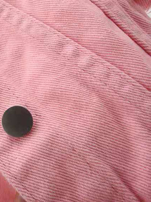 Pink corduroy trucker jacket detail with silver button.