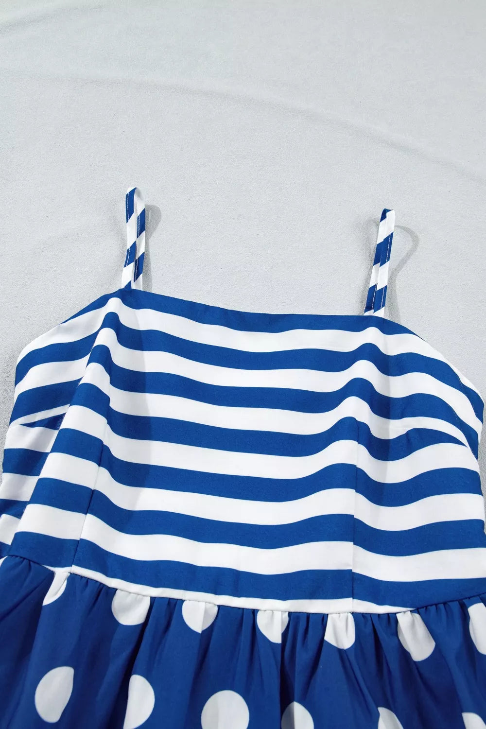 Blue and white striped maternity swim dress with polka dot skirt and spaghetti straps.
