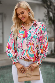 Abstract print blouse with gathered cuffs in hot pink and pastel blue, featuring a collared neckline and long sleeves.