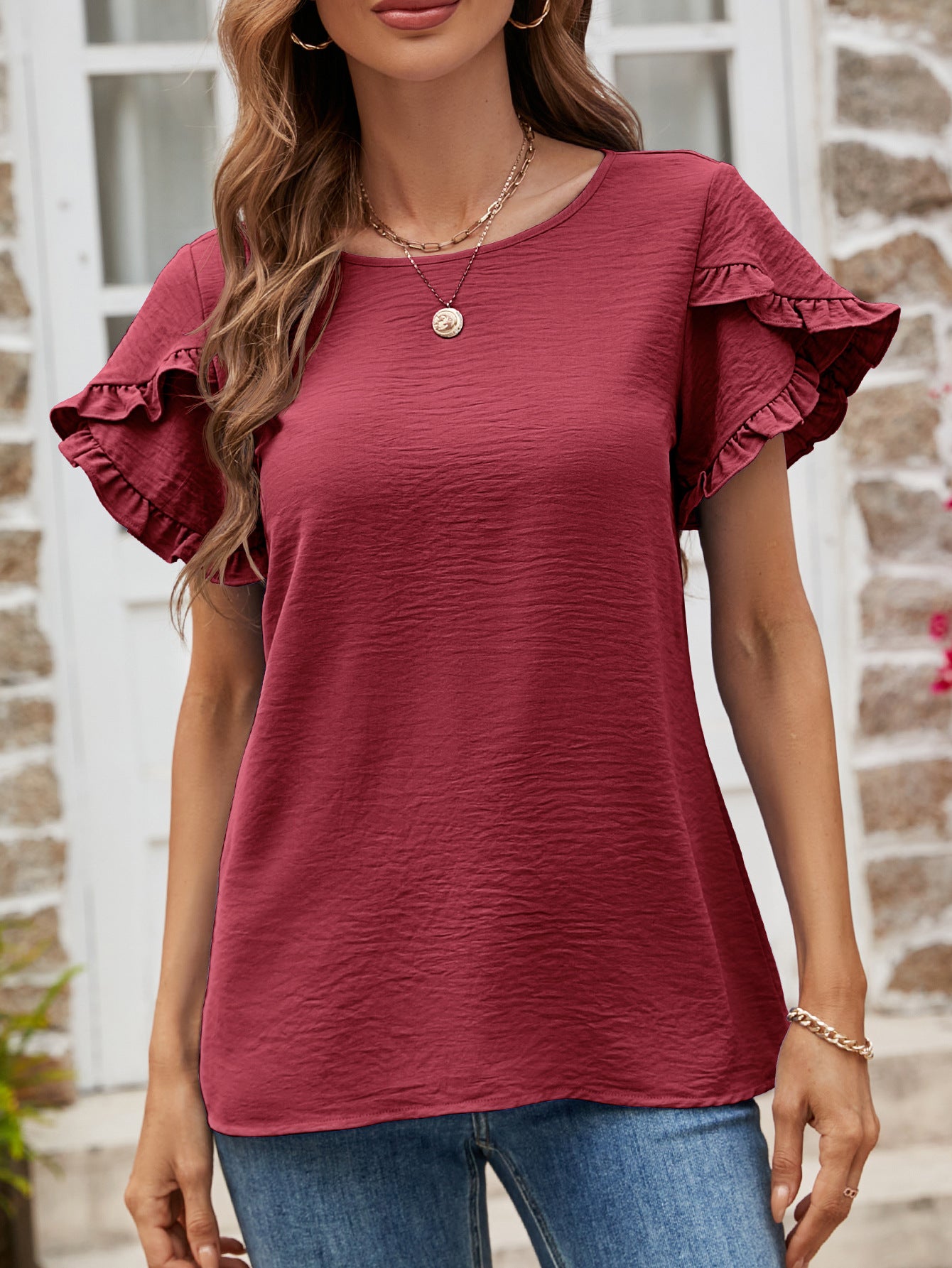 Burgundy t-shirt with textured fabric and ruffled cap sleeves.