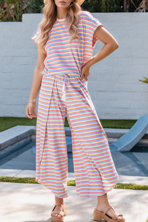 Rainbow stripe culotte jumpsuit with drawstring waist and wide legs in cotton.