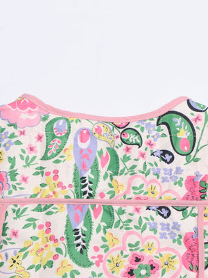 Paisley quilted jacket with pink trim and a colorful floral print.