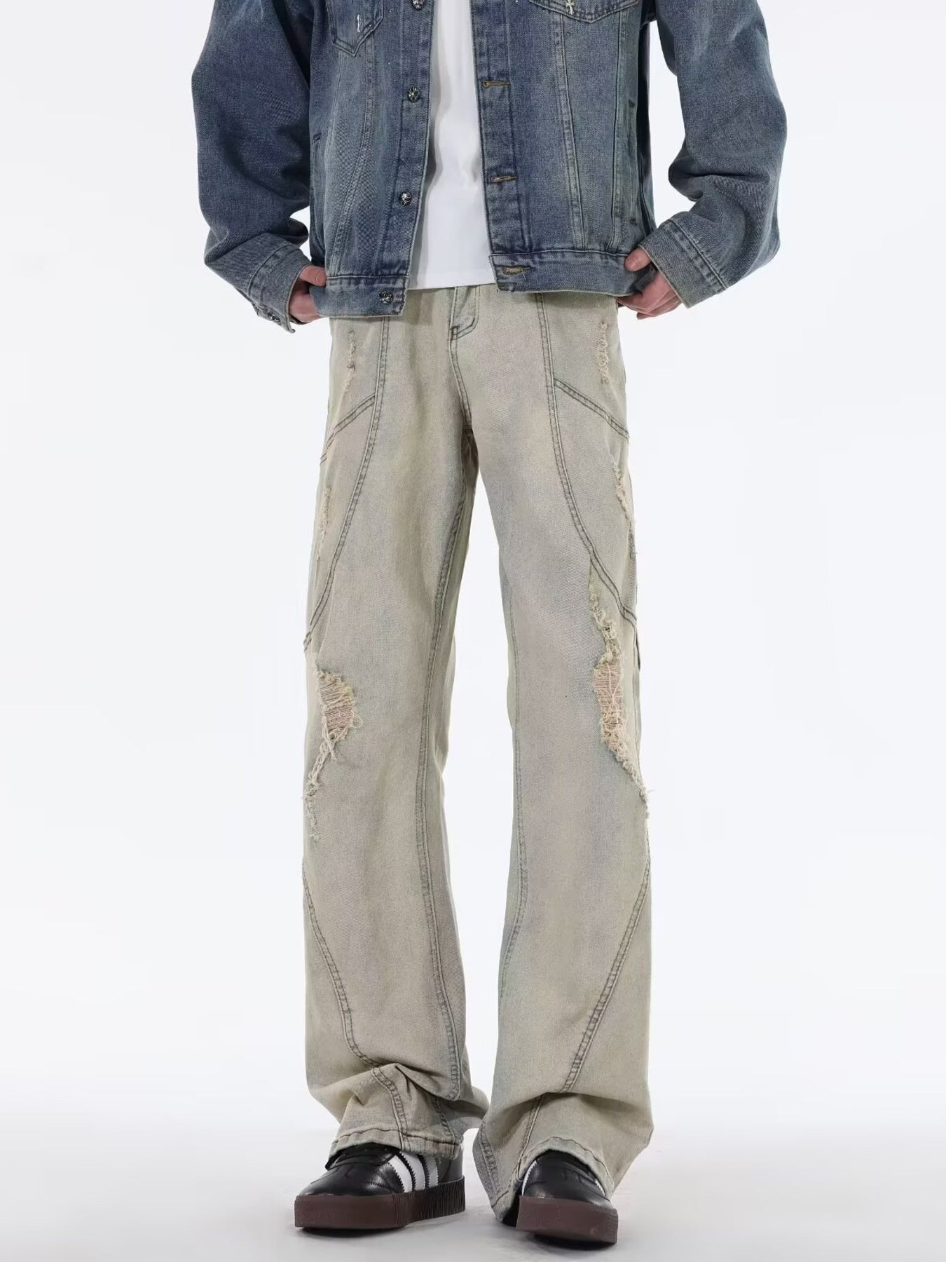 Men's beige wide leg jeans with distressed details and panel stitching