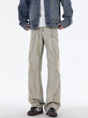 Men's beige wide leg jeans with distressed details and panel stitching