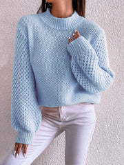 Pastel blue acrylic knit sweater with mock neck and textured puff sleeves.