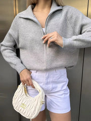 Gray ribbed knit zipper cardigan with a stand-up collar and full zip closure.