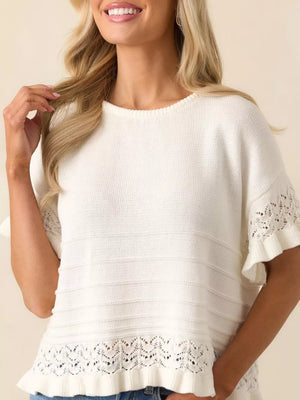 White knit top with crew neck, short sleeves, and delicate lace trim at hem and cuffs.