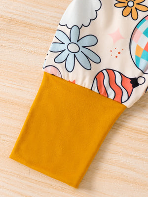 Baby one-piece with playful holiday print and mustard yellow sleeve.