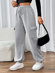 Light gray wide-leg sweatpants with cargo pockets and drawstring waist.