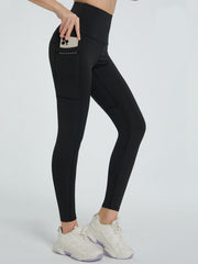 Black pocketed sculpt leggings with a phone in the side pocket.