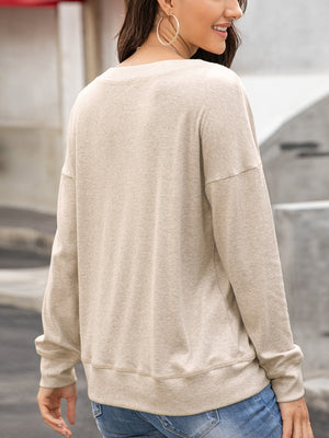 Henley-inspired drop shoulder sweatshirt in camel with crew neck and long sleeves.