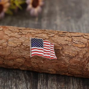 Waving flag enamel pin with red, white, and blue stripes and stars.