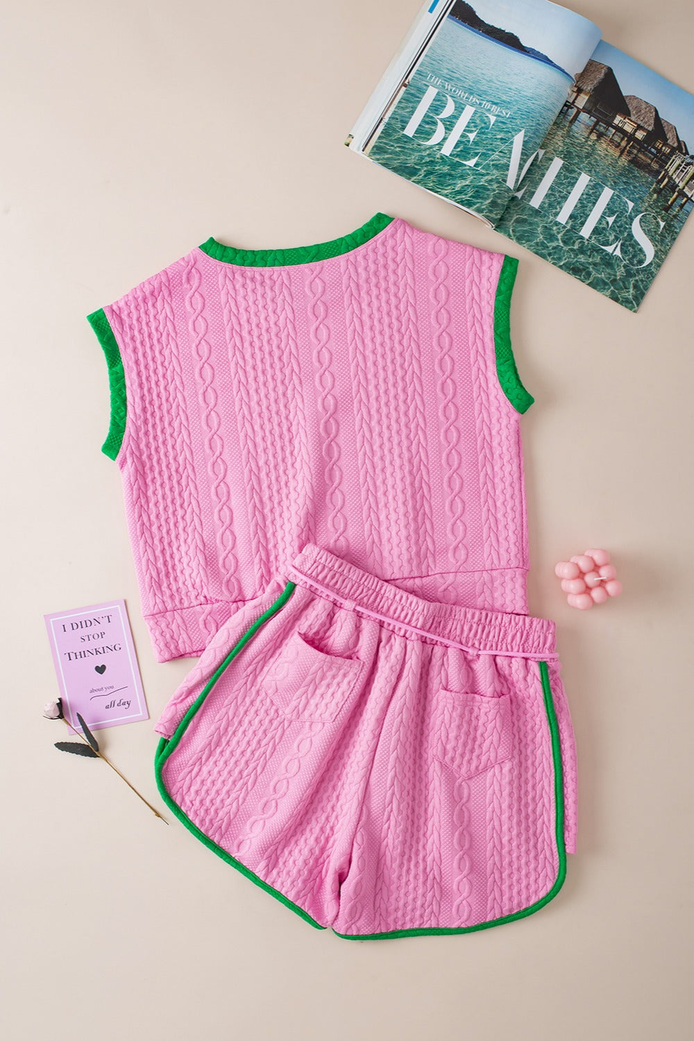 Pink cable knit loungewear set with green trim, sleeveless top and shorts.