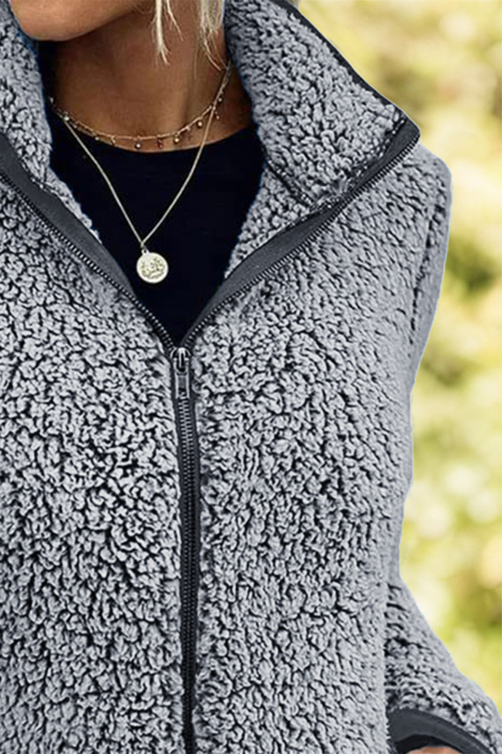 Teddy fleece zip-up jacket in dark gray with a stand-up collar and black zipper.