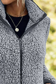 Teddy fleece zip-up jacket in dark gray with a stand-up collar and black zipper.
