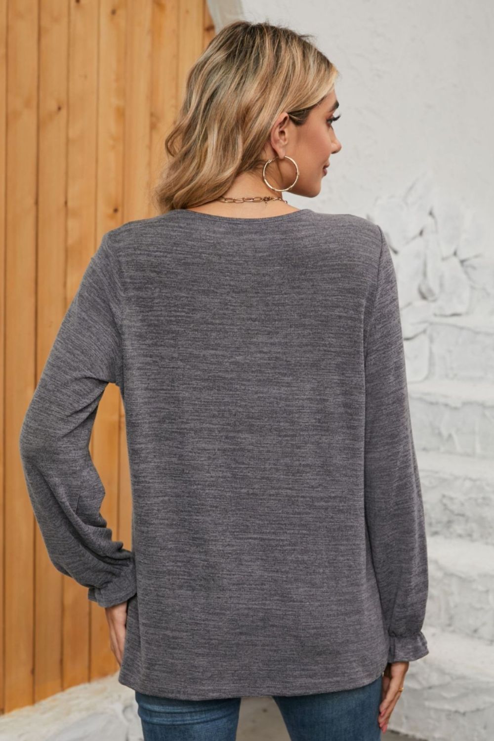 Dark Gray knit top with ruffled cuffs and long sleeves.
