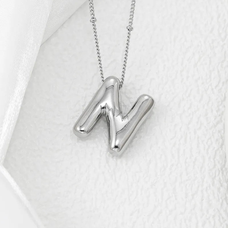 Silver letter N pendant necklace with a beaded chain