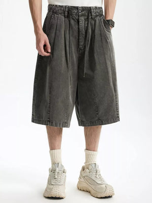 Men's dark gray cotton wide-leg chino shorts with drawstring and pleats.