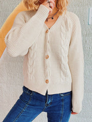 Beige cable knit raglan cardigan with button front and V-neck.