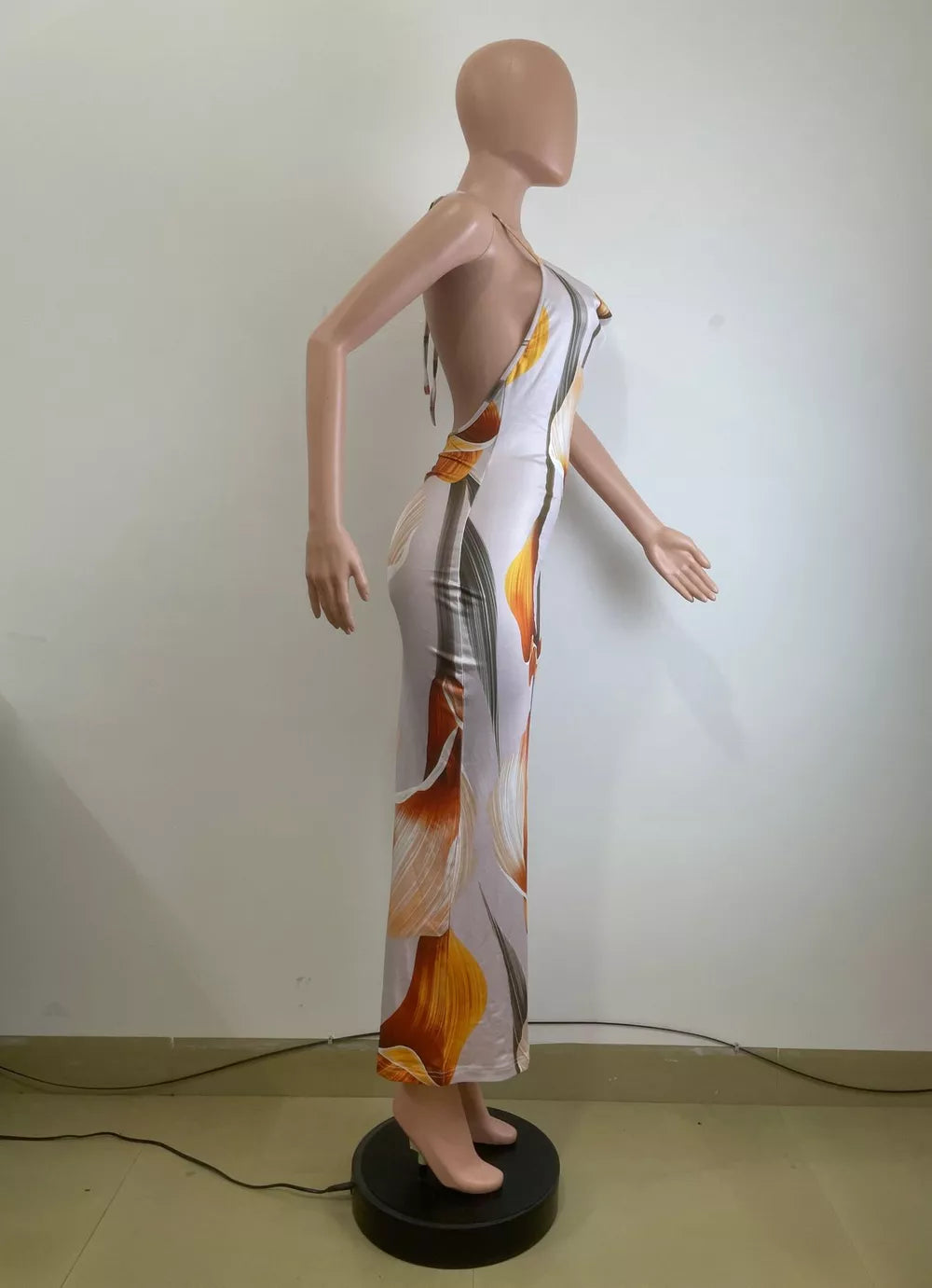 Maxi dress with cowl neck, backless design, and floral print.