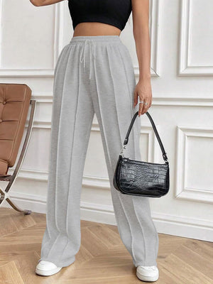 Light gray pleated palazzo drawstring trousers with a wide leg and a casual fit.