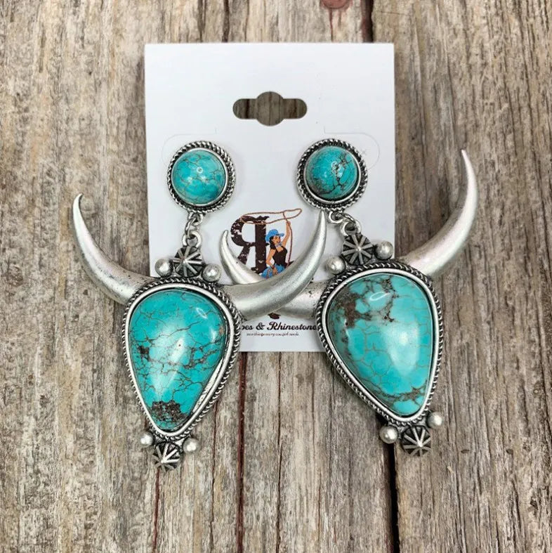 Southwestern crescent drop earrings with turquoise stones and silver alloy bull horns.
