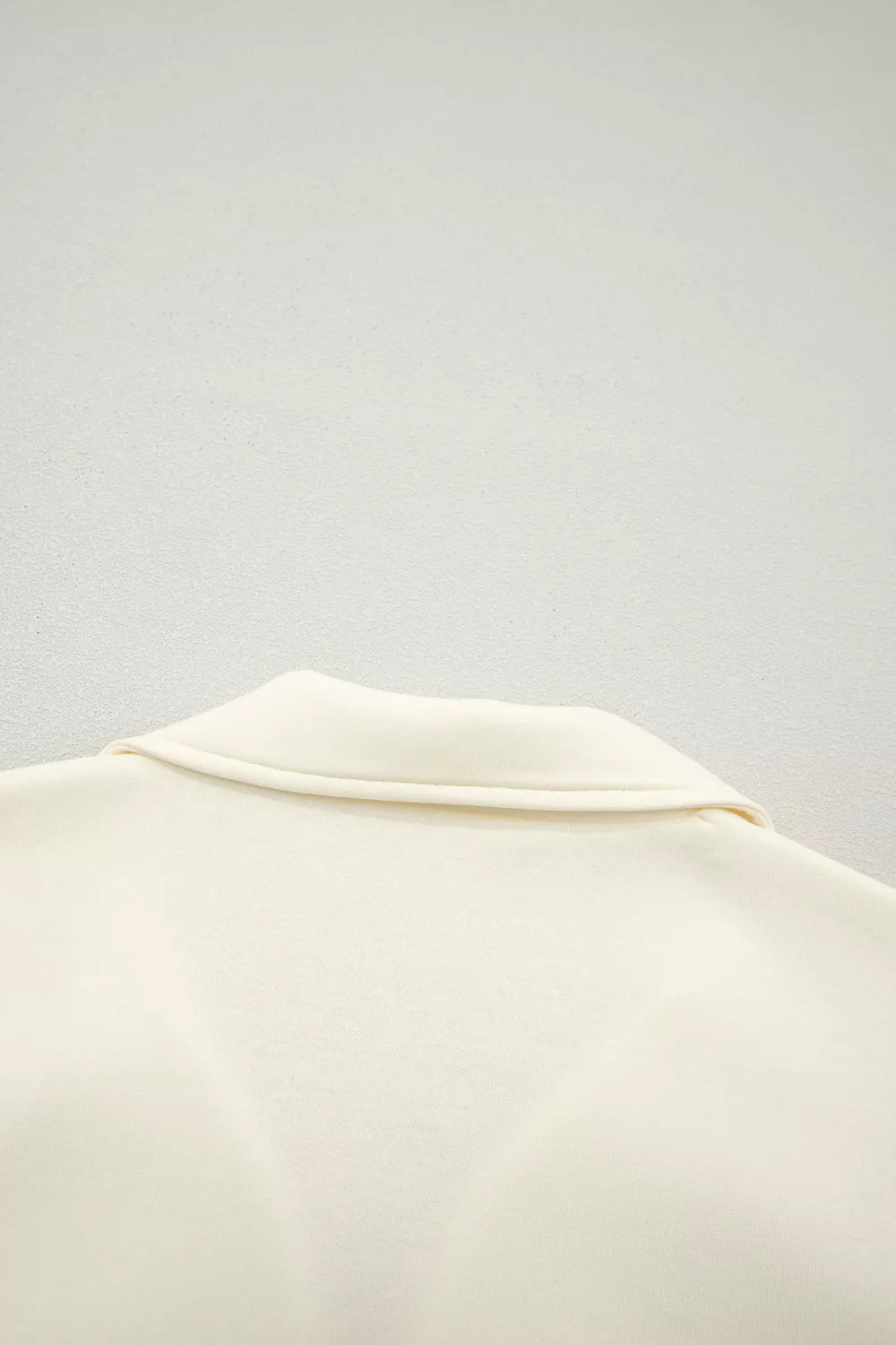 Cream cotton blouse with stand-up collar and ruffled detail