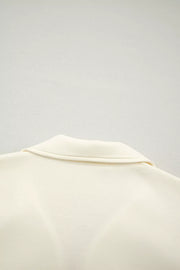 Cream cotton blouse with stand-up collar and ruffled detail