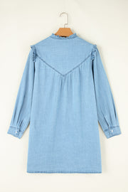 Light blue denim shirt dress with ruffled yoke and collar, long sleeves, and button cuffs.