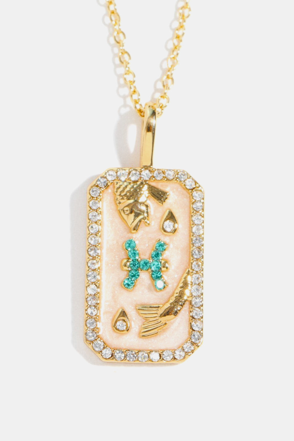 Pisces zodiac sign crystal pendant necklace with 14K gold plating and rhinestones.
