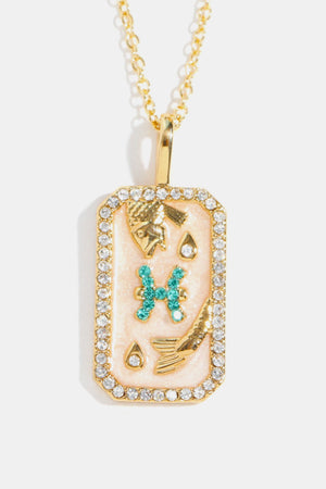 Pisces zodiac sign crystal pendant necklace with 14K gold plating and rhinestones.