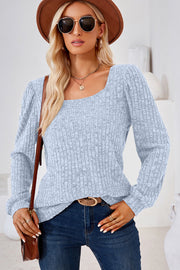 Light blue ribbed top with puffed sleeves and square neckline.