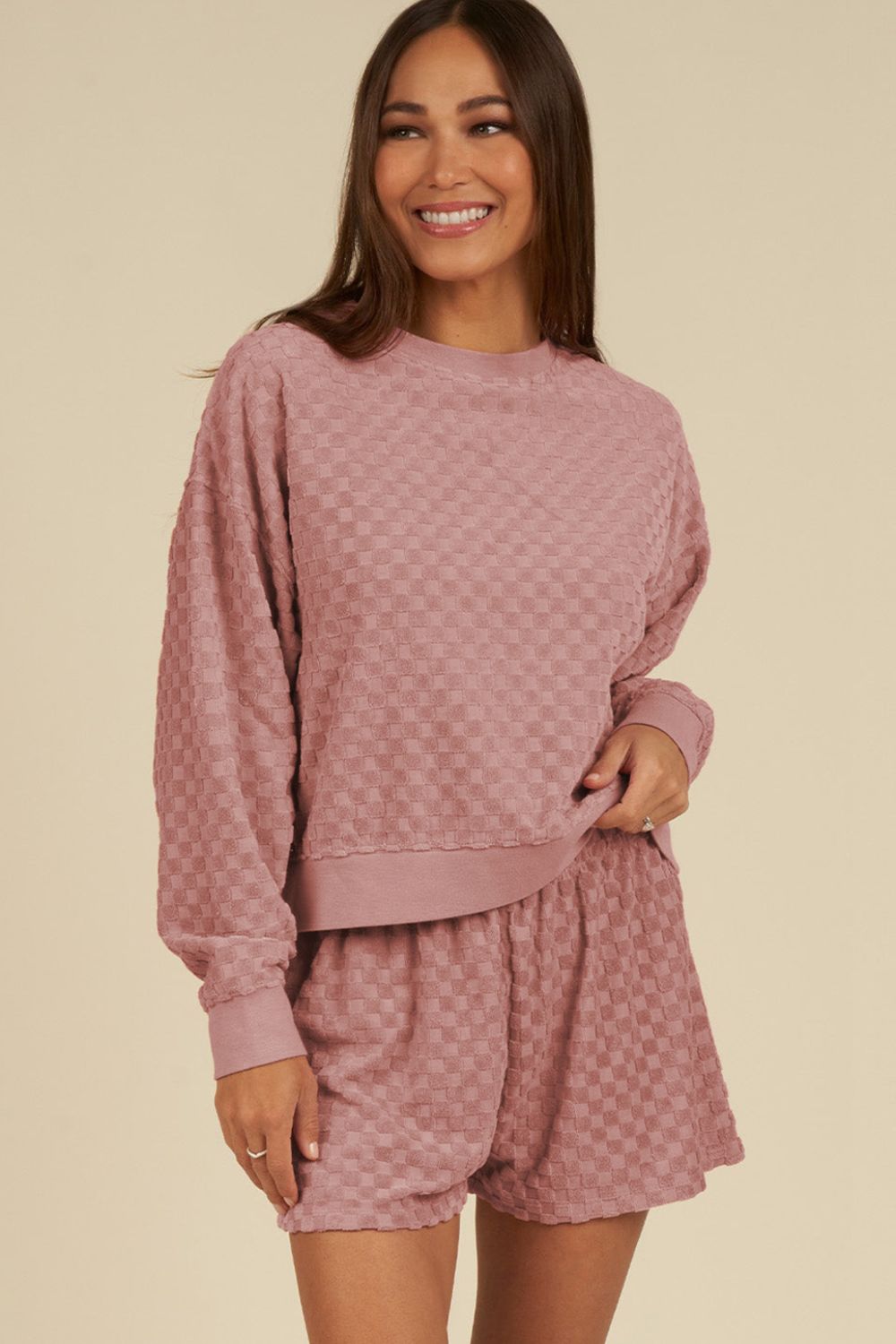 Dusty pink textured checkered lounge set with crewneck sweatshirt and shorts.