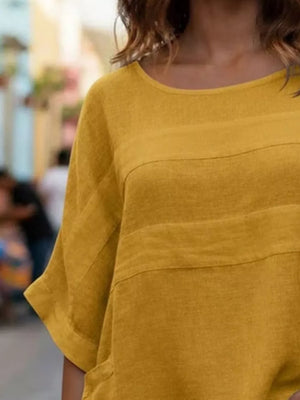 Yellow relaxed fit blouse with horizontal seam details and short sleeves.