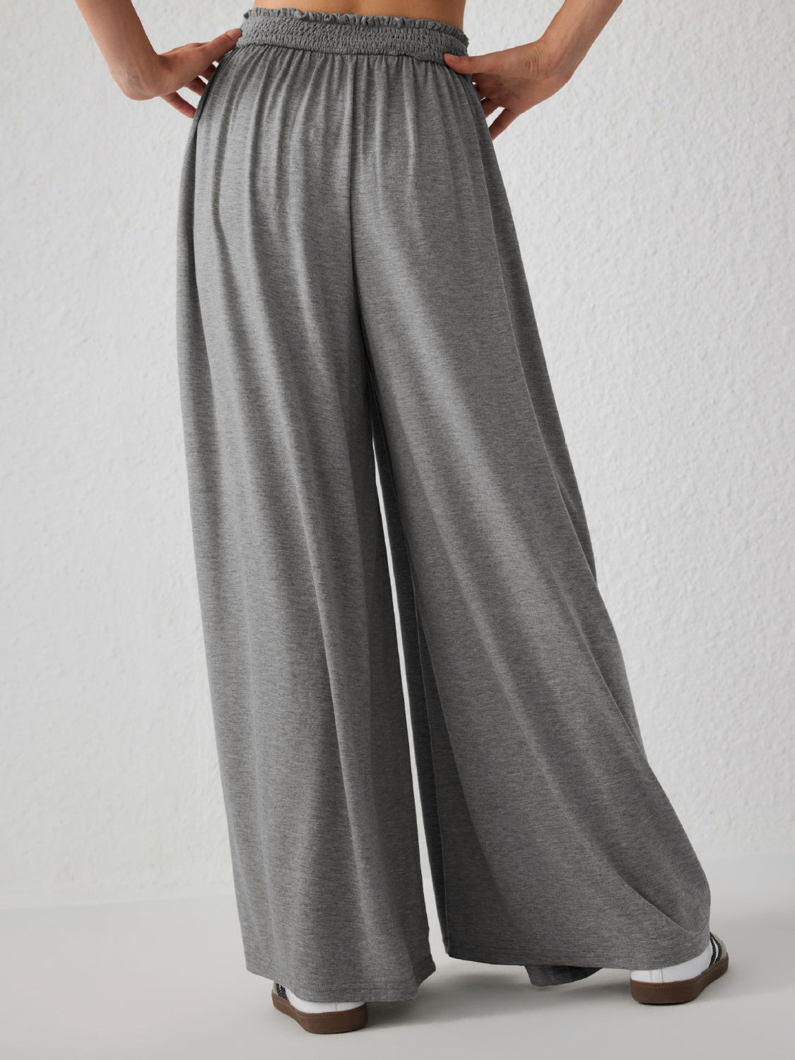 Gray jersey wide-leg trousers with elasticated waist and drape front detail.