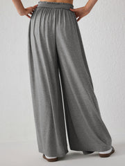 Gray jersey wide-leg trousers with elasticated waist and drape front detail.