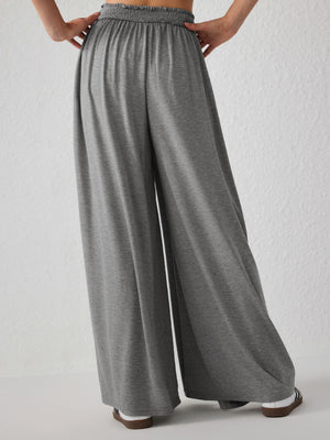 Gray jersey wide-leg trousers with elasticated waist and drape front detail.