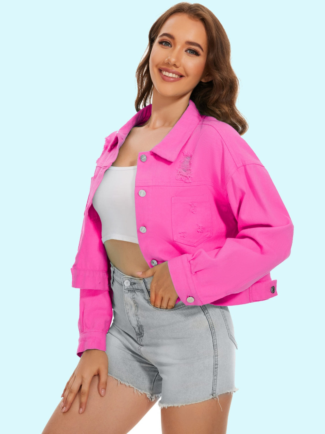 Hot Pink distressed denim trucker jacket with button front and frayed details.