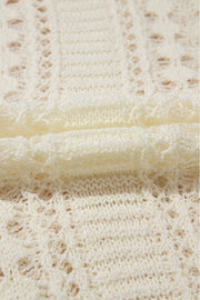 Beige openwork knit beach cover-up with intricate lace-like details.