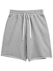Gray relaxed fit jogger shorts with raw edge hem and white drawstring.