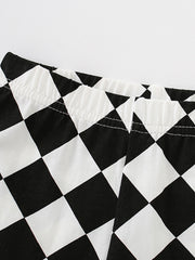 Black and white checkerboard baby shorts with elastic waistband