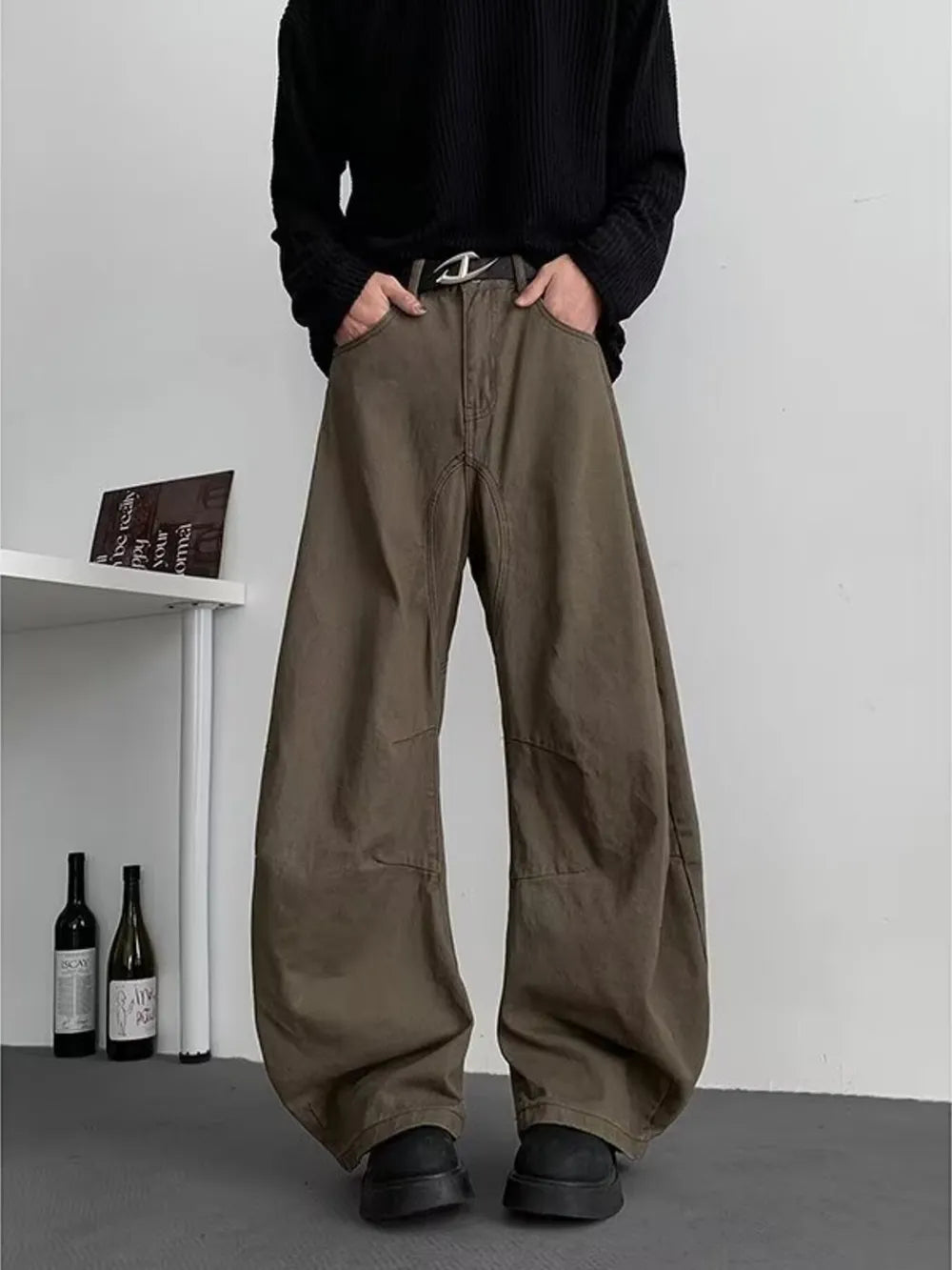 Earthy brown oversized men's sweatpants with pockets and a belted waist.