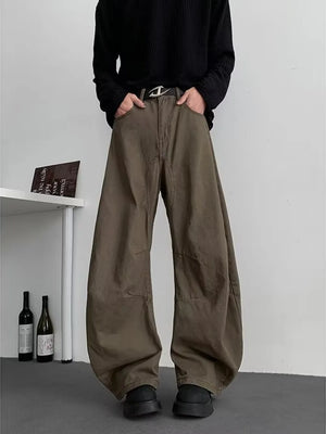 Earthy brown oversized men's sweatpants with pockets and a belted waist.