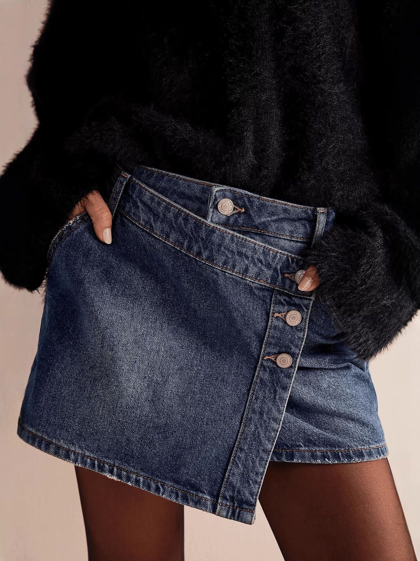 Dark blue denim skort with asymmetrical button-front detail and frayed hem